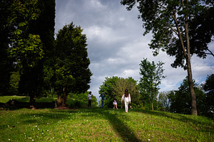 Family enjoying a scenic walk in nature surrounded by green grass and trees, a Person Photo by AS photostudio