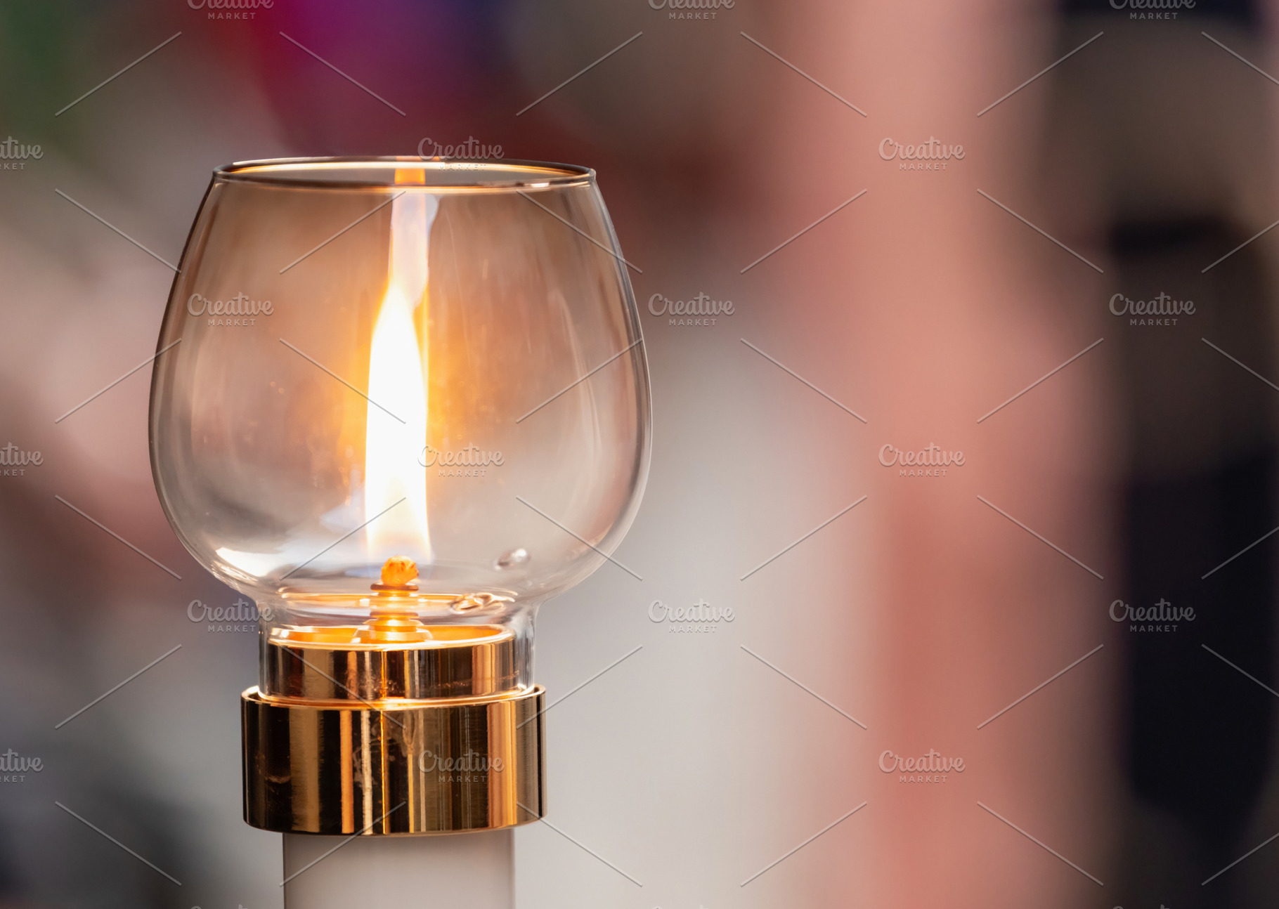 Burning candle illuminating a glass lantern during a religious procession, a Holiday Photo by Antonio Gravante Market