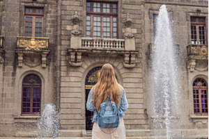 Young woman tourist standing near, an Architecture Photo by Elizaveta Galitskaya