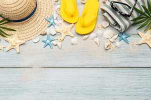 Summer accessories creating a frame on a wooden background with, a Holiday Photo by Olena Rudo