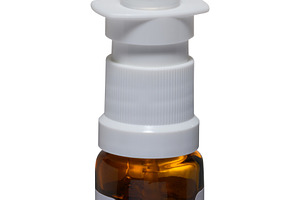 Glass bottle with nasal spray and dispenser on isolated backgrou, a Health & Medical Photo by ndanko
