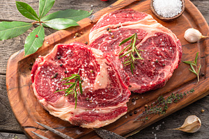Raw beef steaks with herbs, a Food & Drink Photo by Volff