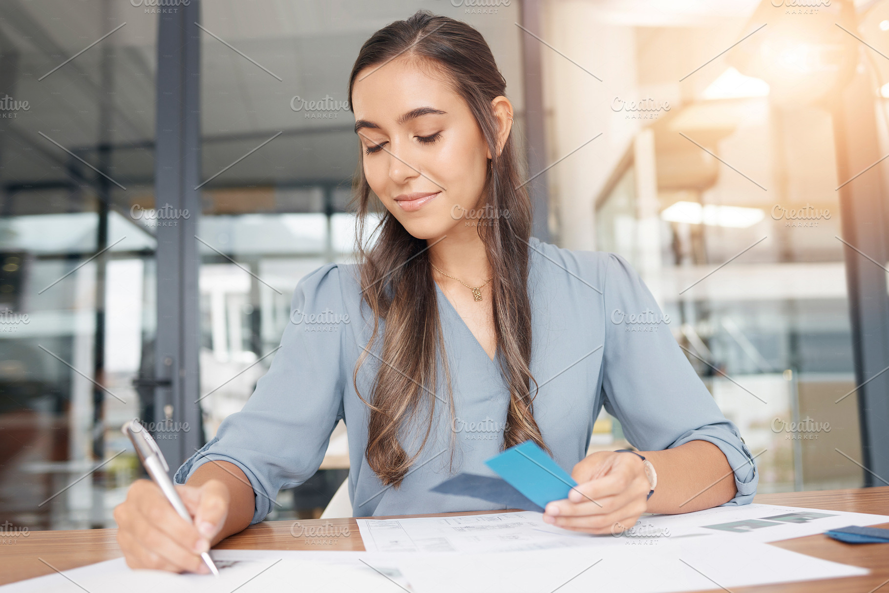 Business woman writing documents at office desk of administration, strategy solution or project notes. Female worker planning paperwork, ideas or management of professional company reports in startup, a Photo by Peopleimages.com