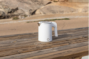 White electric kettle on the gray
