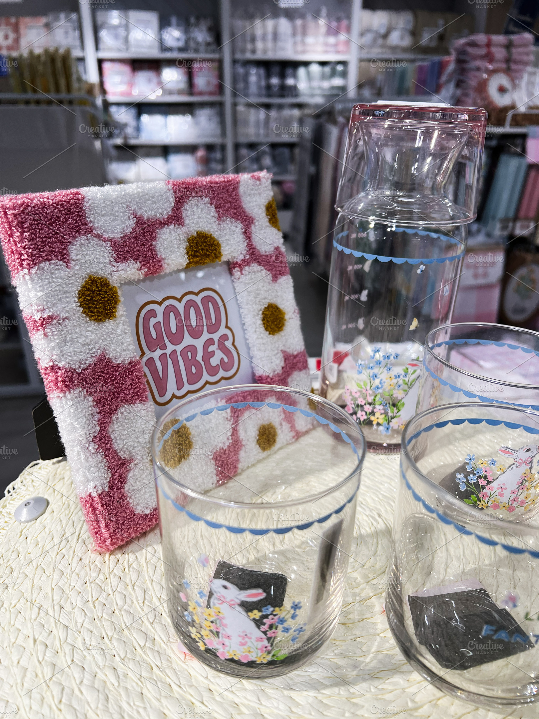 Decorative drinkware set with floral motif and good vibes sign i, a Photo by AS photostudio