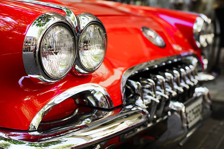Headlights of a red vintage car featuring car, design, and icon