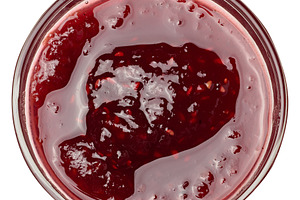 Raspberry jam in a glass bowl on isolated background, a Food & Drink Photo by ndanko