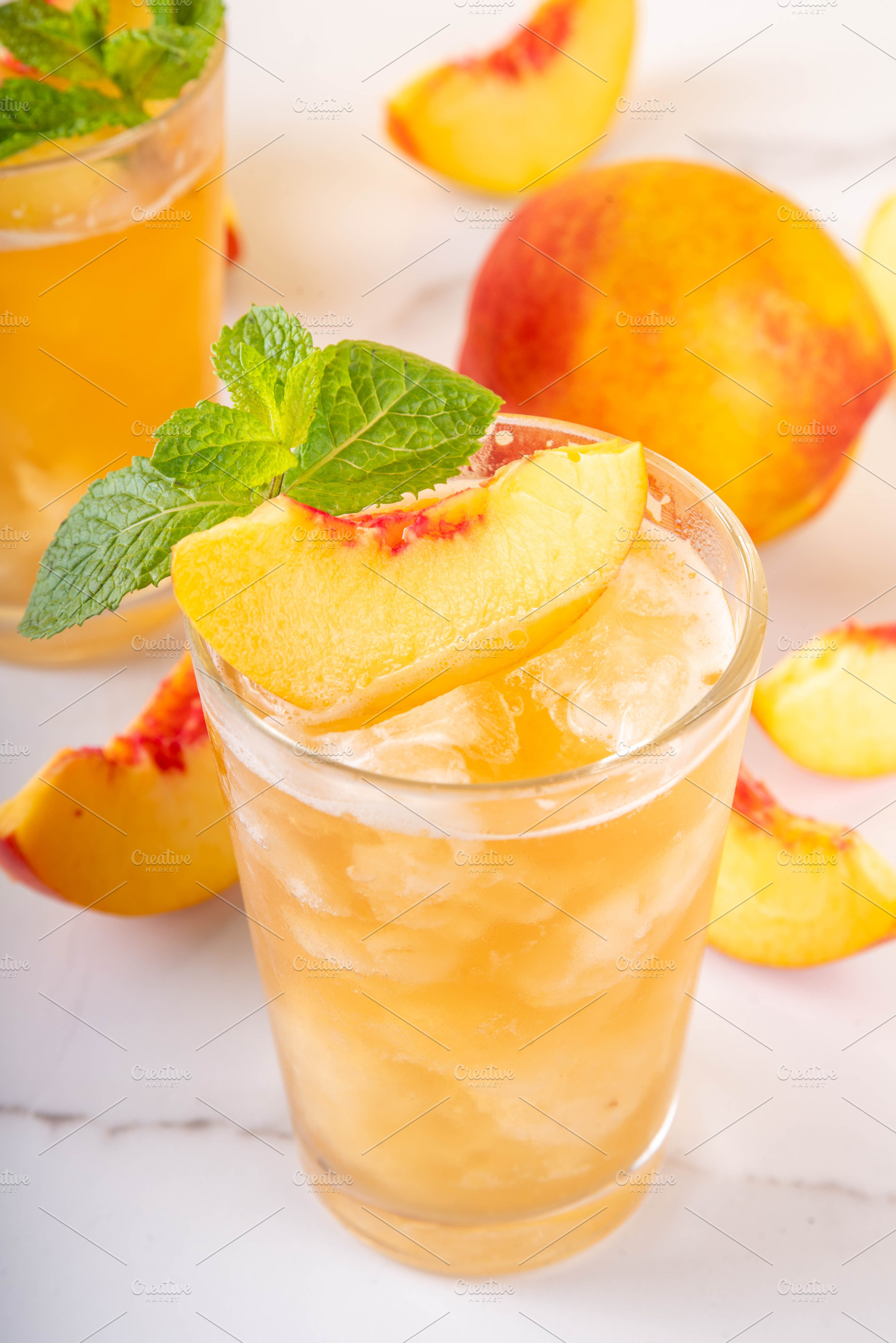 Summer cold drink, peach iced tea slushie cocktail, a Food & Drink Photo by Rimma