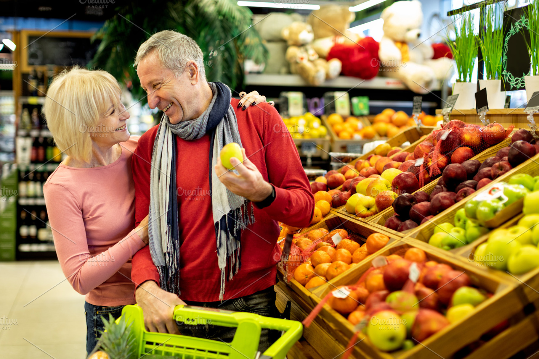 Happy senior family choosing eco fruits at store, a Photo by Prostock-Studio