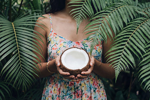 Woman Holding Half a Fresh Coconut, a Beauty & Fashion Photo by Virgo Studio