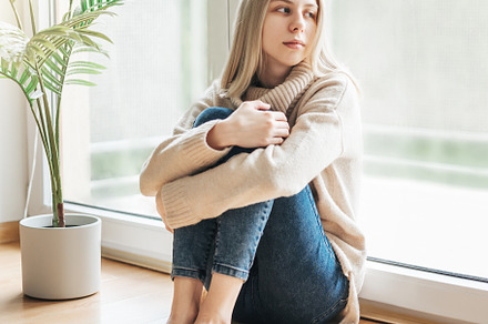 Sad girl near window thinking about something, a Person Photo by Olena Rudo