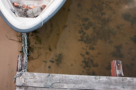 Old boat on an old wooden blue wharf on a river-lake. Top view,, a Transportation Photo by TanaCh