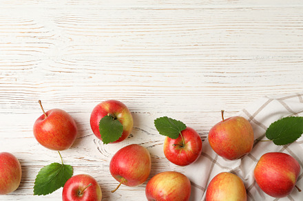 Composition with apples and towel on white wooden background, to, a Food & Drink Photo by AtlasStudio