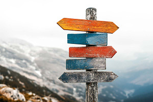 Wooden post with directional signs, a Holiday Photo by VetalStock