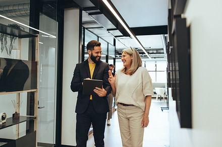 Diverse businesspeople laughing during a discussion, a Person Photo by Jacob Lund