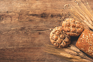 Bread on wooden background stock photo containing wheat and bread