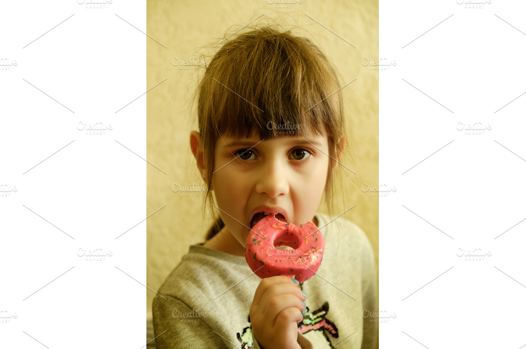 Little girl eating a colorful donut, a Food & Drink Photo by Rohan Photography