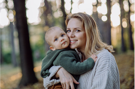 Mother holding her little baby son, a Nature Photo by HalfPoint