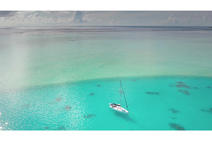 Sailboat anchored in clear turquoise, a Nature Photo by Goinyk