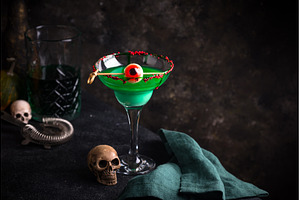 Eerie green Halloween cocktail with, a Food & Drink Photo by Yulia Furman