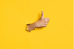 Thumb up hand gesture through hole, a Business Photo by Gladkov photography
