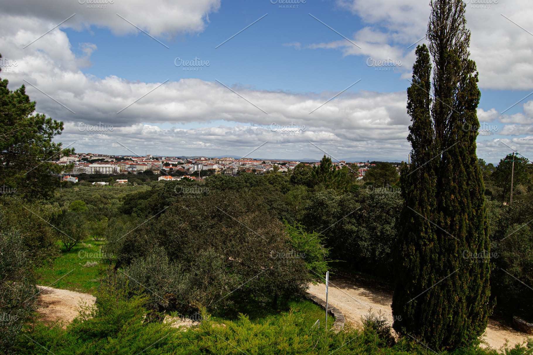 Panoramic view of Fatima, Portugal under a blue sky with surrounding nature, a Photo by AS photostudio