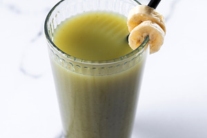 Green smoothie with spinach,banana, apple, and lemon on white marble, a Food & Drink Photo by etorres69