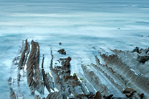 Twilight ocean coast with ribbed stratiform rock., a Nature Photo by YuriyB
