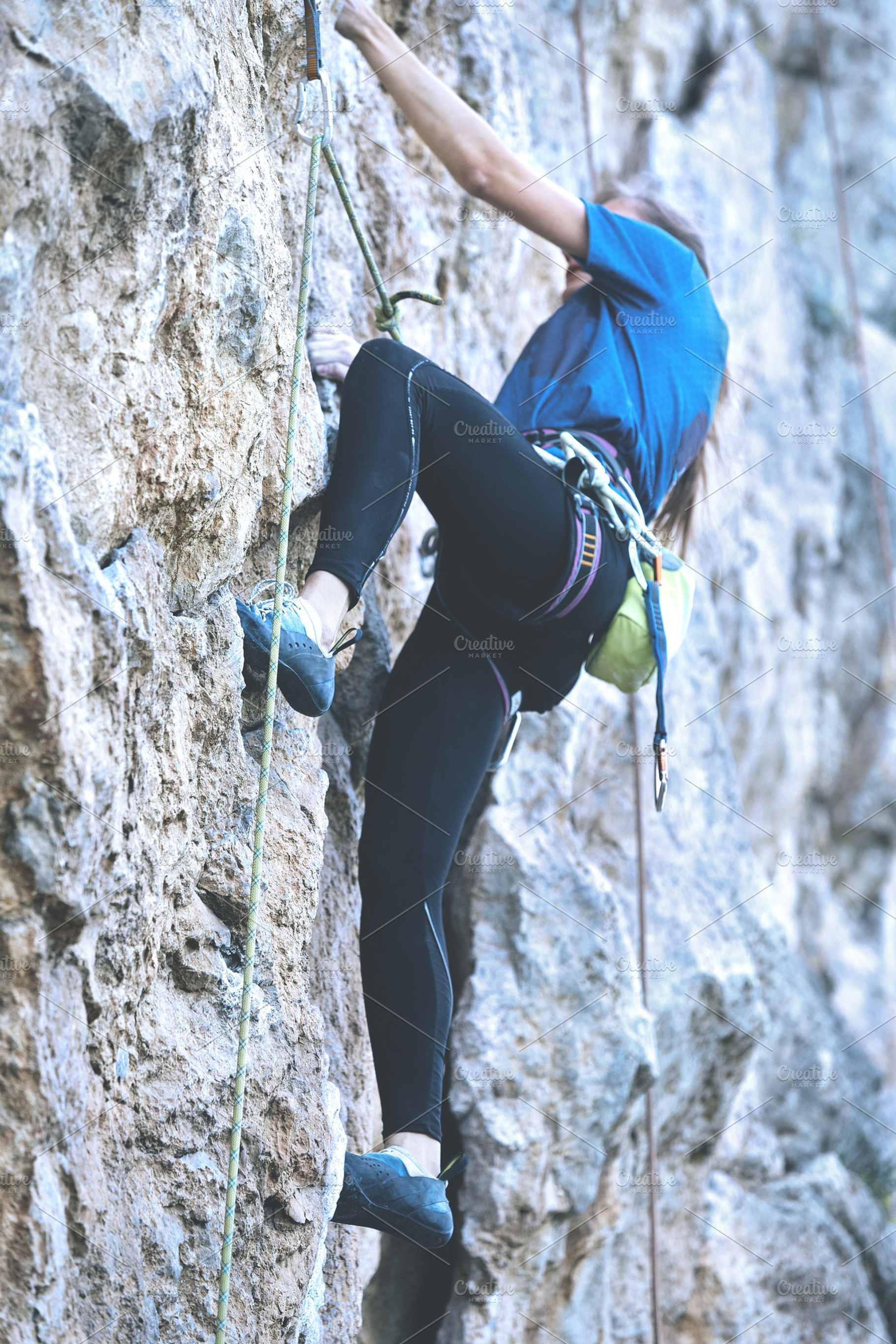 Woman rock climber on the cliff featuring woman, athletic, and climber, a Sports & Recreation Photo by vitaliymateha photography