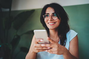 Happy businesswoman using smartphone