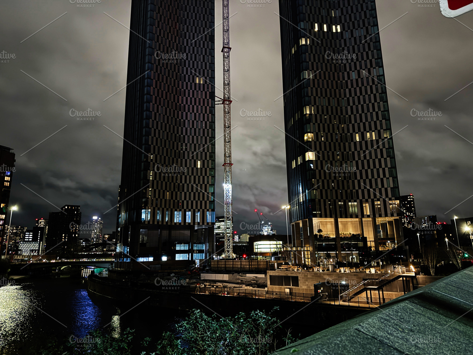 Night view of Manchester Salford skyscrapers under construction by the river, c, a Photo by AS photostudio