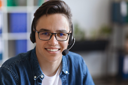 Call Center Operator. Closeup shot of friendly customer service worker in heads, a Photo by Prostock-Studio