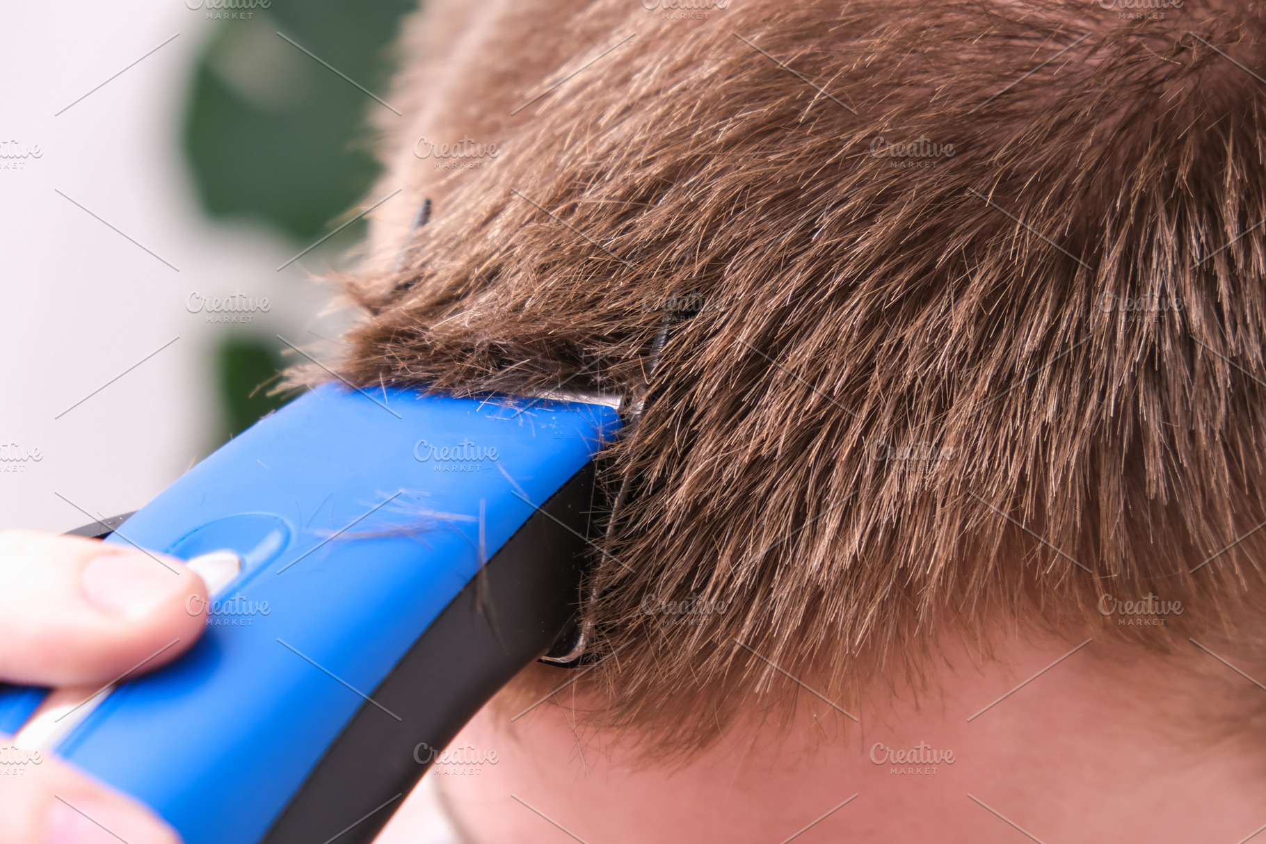 A man cuts his hair with clipper. Cutting a short hairstyle at home. Close-up., a Technology Photo by Detriana