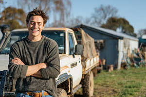Happy farmer standing by his truck o, a Photo by Pixeness Studio