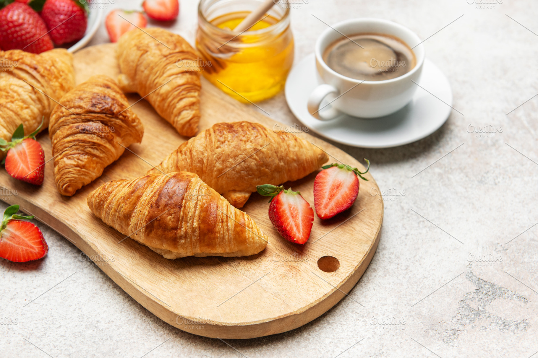 Delicious french breakfast with croissants, coffee, strawberries, a Food & Drink Photo by Olena Rudo