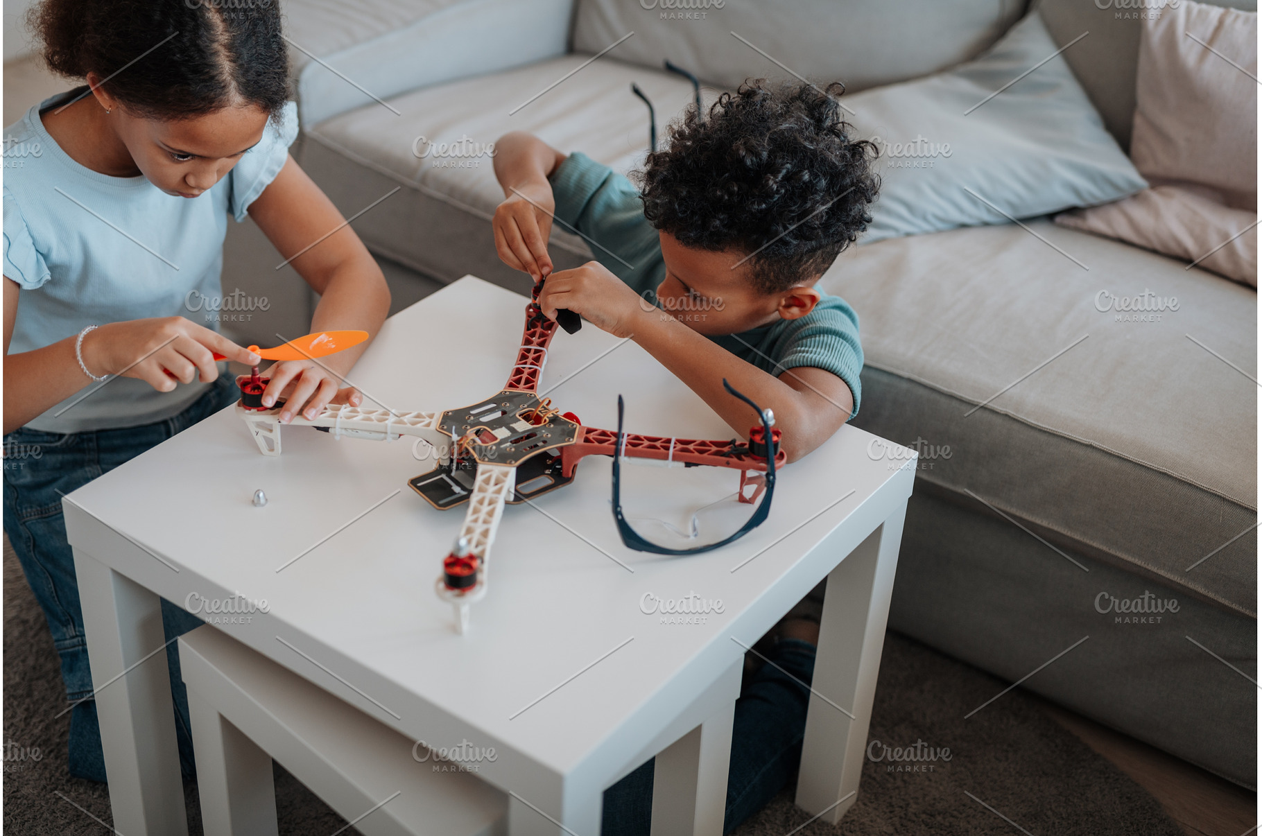 Kids playing with drone at home., a School & Education Photo by HalfPoint