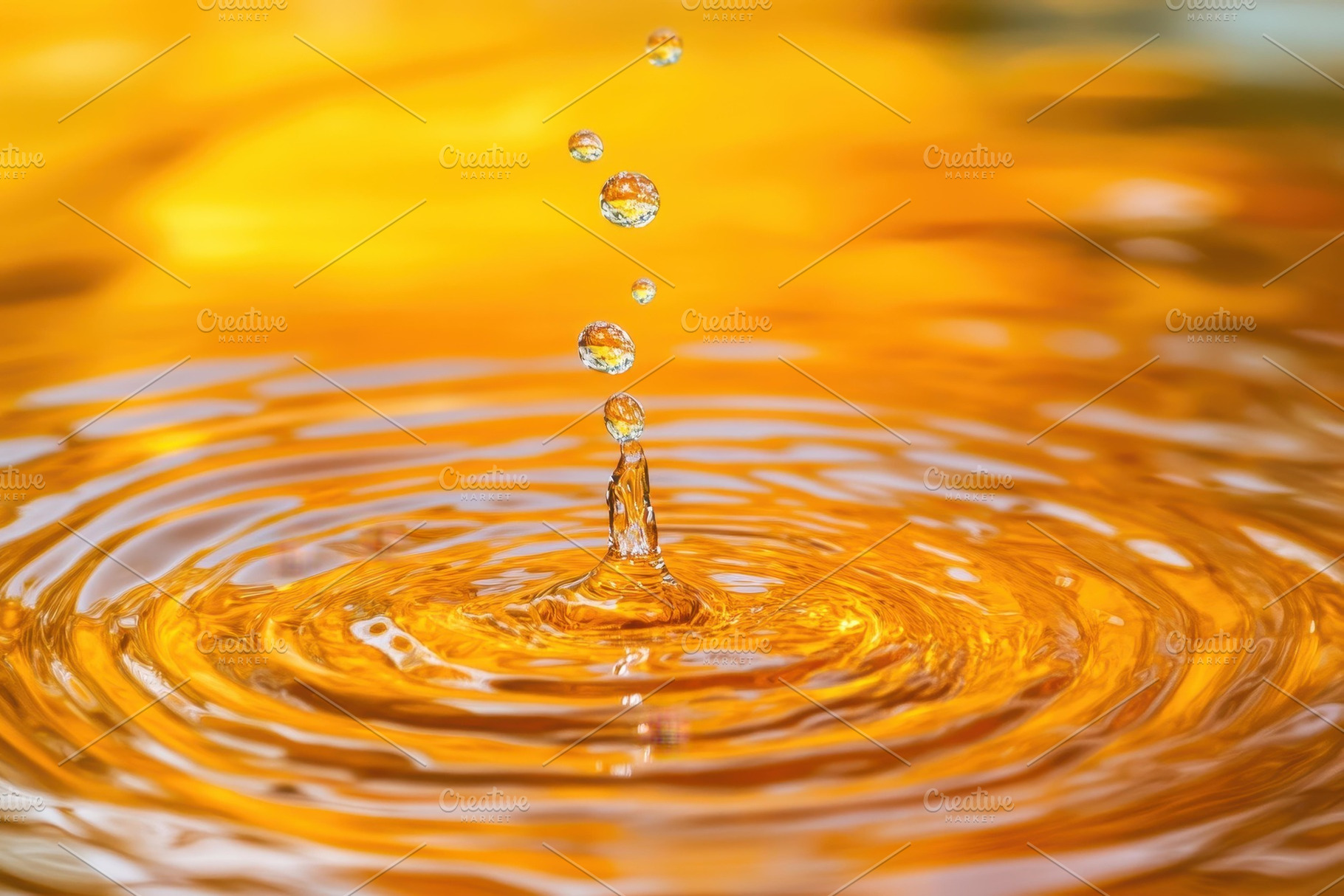 Water droplets create ripples on a s, a Photo by Tanuart