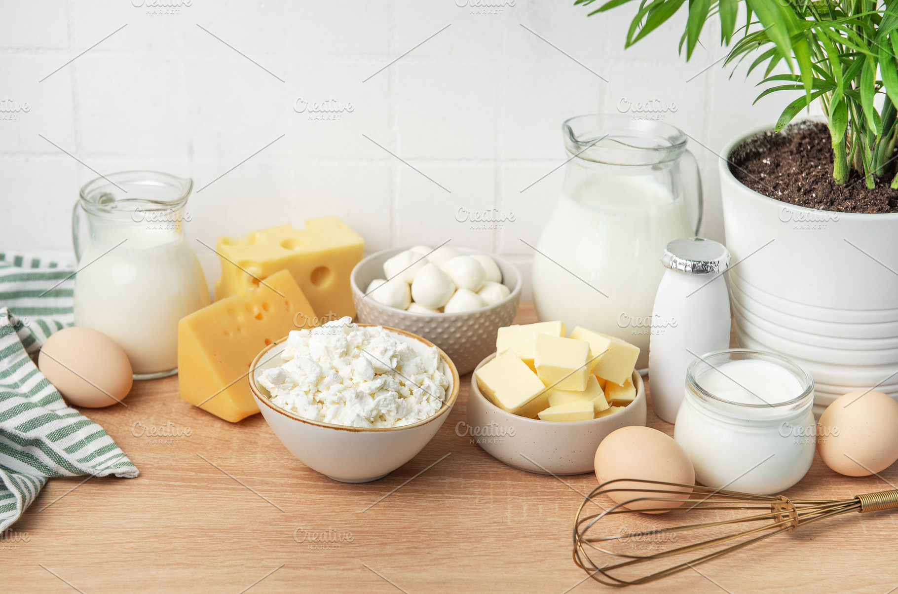 Assortment of fresh dairy products on wooden table, a Food & Drink Photo by Olena Rudo