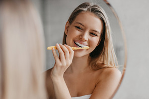 Oral hygiene, healthy teeth and care. Young woman brushing teeth with toothbrus, a Photo by Prostock-Studio