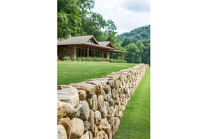 Rustic Stone Wall and House in, an Architecture Photo by Lermont51