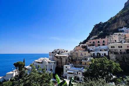Scenic coastal village with colorful buildings and lush greenery. Positano, Ita, a Photo by AS photostudio