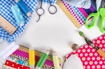 Colorful fabric pieces with sewing tools, an Industrial Photo by Rimma