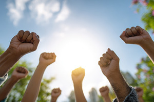Hands raised in unity during march, a Photo by Beautiful things
