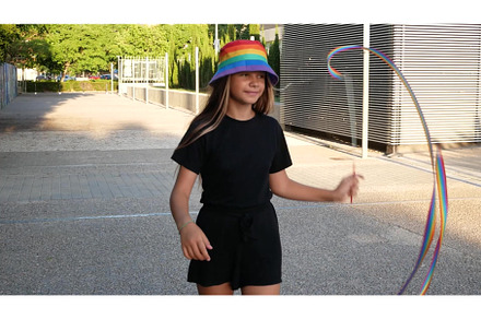 A girl and a woman in rainbow hats