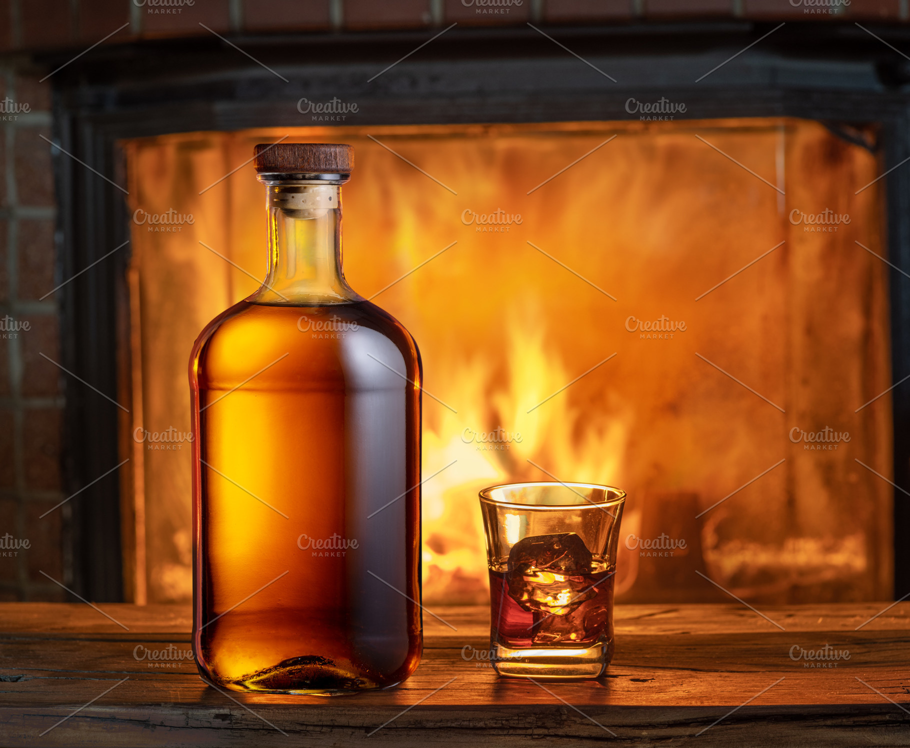 Glass of whiskey and whiskey bottle on old wooden table and blur, a Food & Drink Photo by Volff