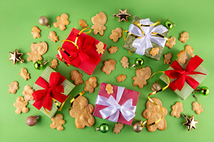 Christmas background with gingerbread man cookies, gifts and bau, a Photo by Rimma