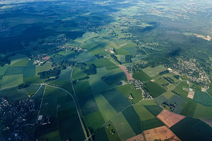 Aerial view of patchwork fields and villages near Paris, France with sunlight a, a Photo by AS photostudio