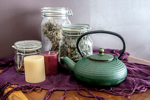 Teapot with candles and tea