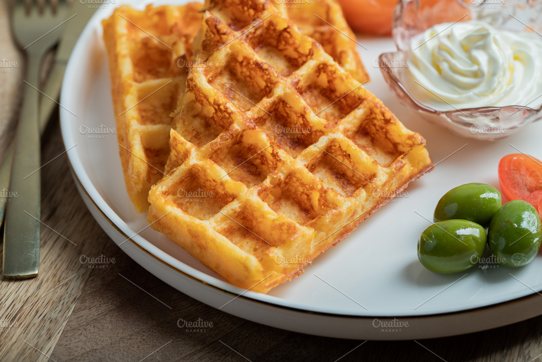 Crunchy waffle fries with sour cream dip served in a basket, a Food & Drink Photo by Budarinphoto