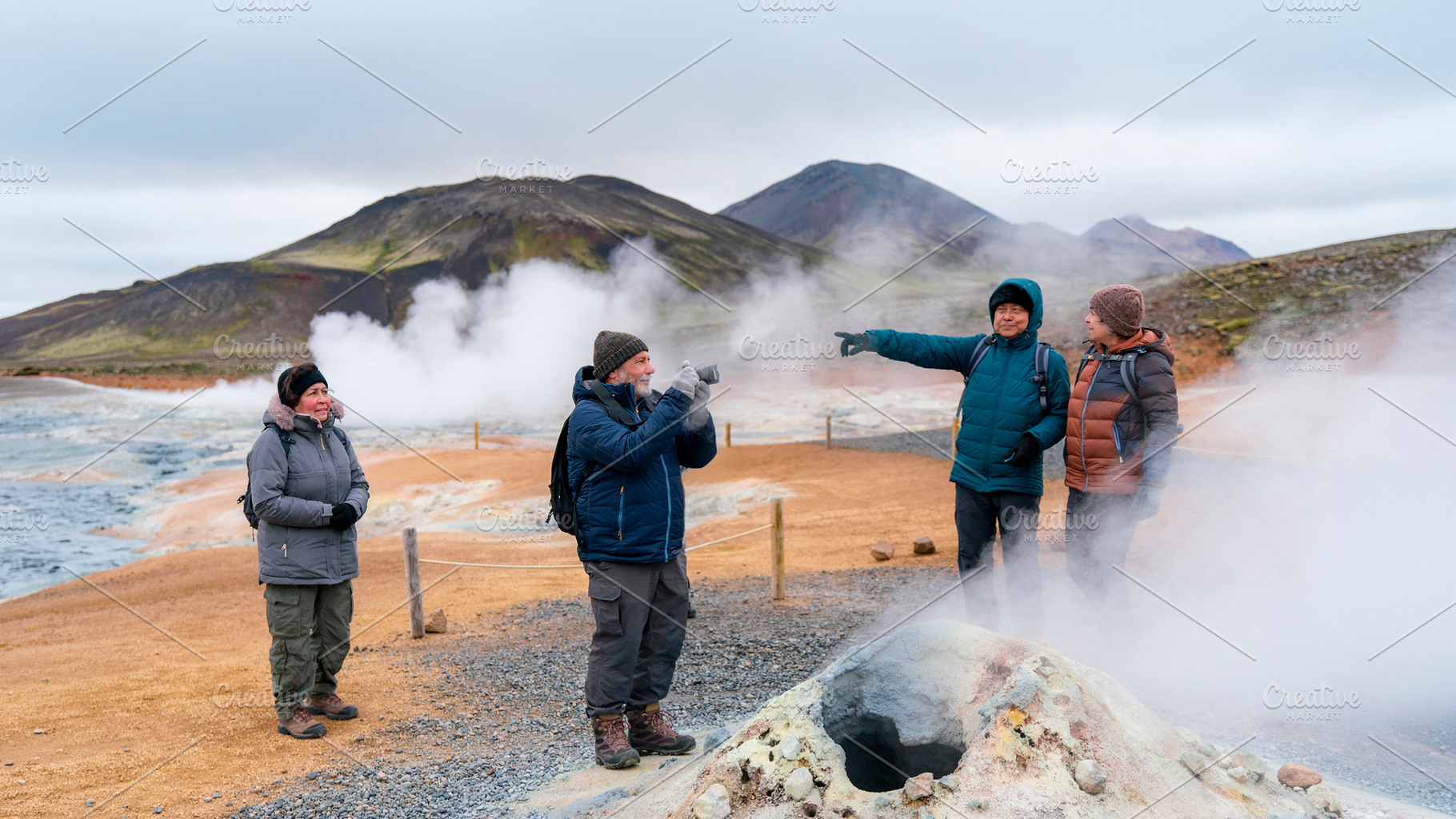 Mature travelers walking along a marked path through geothermal, a Person Photo by DanFLCreativo